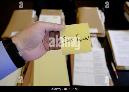 Sticky Note dans la main Businessman 24 fichiers Dossier Groupe de fixer des objectifs de Motivation Message Banque D'Images