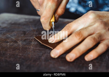 Professionnel hommes skinner, fourreur travaillant avec la peau vison à l'atelier, atelier. La mode et le travail du cuir concept Banque D'Images