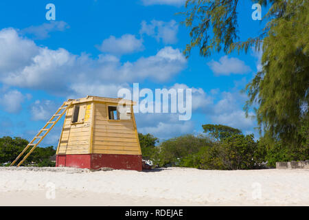 L'original en bois jaune lifeguard station sur la plage de l'entreprise, de la Barbade, baigné dans un ciel bleu magnifique avec des nuages gonflés. Banque D'Images