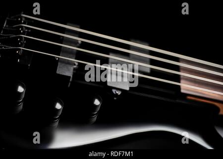 Sleek black bass guitar close up Banque D'Images