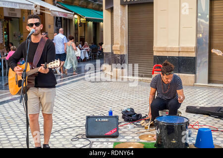 Malaga, Espagne - 12 mai 2018. Musicien de rue chanter des chansons et joue de la guitare et du tambour sur l'Felix Saenz Square, la ville de Malaga, Espagne. Banque D'Images