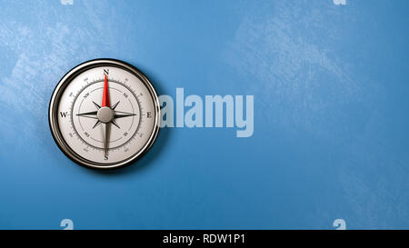 Compas magnétique rouge métallique avec aiguille pointée vers le nord contre un mur bleu plâtrés avec Copyspace, 3D Illustration Banque D'Images