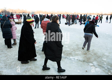 Mesdames ukrainien de différents âges habillés de vêtements chauds pour l'hiver à pied sur la glace et la neige pour prendre part à l'hiver le Christ le baptême d'eau piscine tradition. Banque D'Images