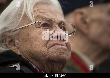 Gisela Rainare, un ancien employé civil à l'ancienne Base aérienne principale Frankfurt, Allemagne, écoute de la musique au cours de la cérémonie de réouverture du pont aérien de Berlin Memorial à l'extérieur de l'Aéroport International de Francfort, Allemagne, 22 novembre 2016. Rainare a travaillé dans le cadre de le Pont Aérien de Berlin, également connu sous le nom d'opération Vittles, qui a livré plus de deux millions de tonnes de nourriture pour les citoyens d'un blocus de Berlin ouest entre juin 1948 et septembre 1949. Banque D'Images