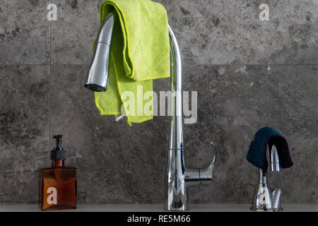 Pompe à savon, chrome robinet d'évier de cuisine, d'un robinet d'eau filtrée avec des chiffons en microfibre, en marbre gris et Dosseret carreau Banque D'Images