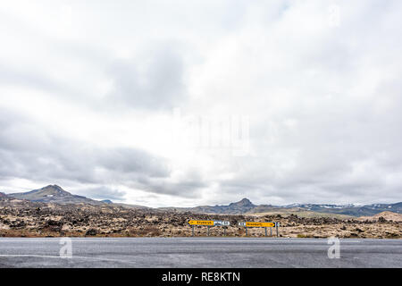 En route champ de lave noire sur la péninsule de Snæfellsnes en Islande avec des panneaux de direction pour Stykkish Stykkisholmur et Grundarfjordur avec personne et vide Banque D'Images