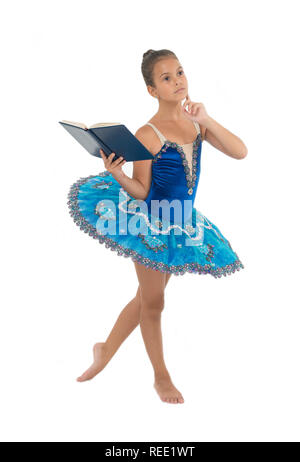 Ballerine fille danser tandis que lire livre. Questions relatives à la carrière de ballet. Priver les enfants ballerine. La plupart du temps passé dans la salle de sport de l'enfant danseur et de formation pratique de la performance. Pas de temps pour l'étude de l'école. Banque D'Images