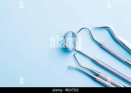 Instruments dentaires. Outils de dentistes sur fond bleu. Banque D'Images