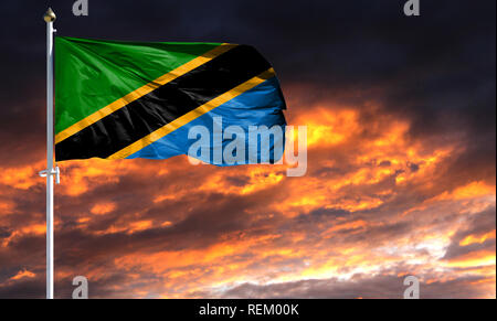 Pavillon de la Tanzanie le mât voletant dans le vent contre un ciel coucher de soleil coloré. Banque D'Images