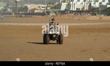 Grande plage d'Agadir au Maroc pour coucher de soleil avec policier en quad Banque D'Images