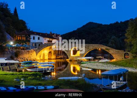 Des bateaux d'Excursion et vieux pont Stari Most, au crépuscule, Rijeka Crnojevica Crnojevic river national park, le lac de Skadar Banque D'Images