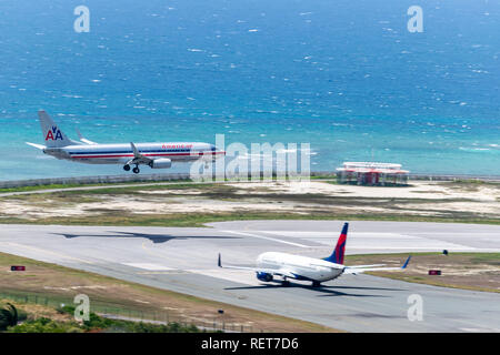 Montego Bay, Jamaïque - 03 juillet 2015 : alors que l'atterrissage des avions American Airlines Delta attend de s'écarter de l'aéroport international de Sangster (MBJ) Banque D'Images