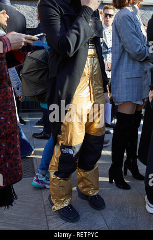 MILAN - JANUARY 14: Man with golden bomber jacket looking at smartphone  before Daks fashion show, Milan Fashion Week street style on January 14,  2018 Stock Photo - Alamy