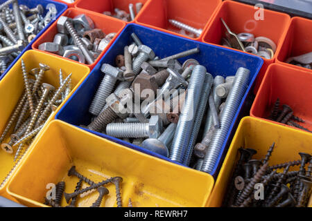 Vis et chevilles pour accueil réparation. Accessoires pour atelier mécanique sur une table. Fond clair. Banque D'Images