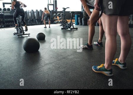 Photos authentiques d'hommes et de femmes travaillant dans une salle de sport. L'équipement de sport utilisé. Banque D'Images