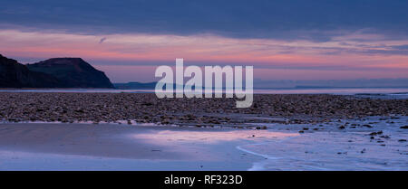 Charmouth, Dorset, UK. 23 janvier 2019. Météo France : un soir d'hiver froid à la station balnéaire de Charmouth, West Dorset. Le ciel sur la Cap d'or et la côte jurassique sont teintées de rose hiver alors que le soleil se couche sur une froide soirée de janvier. Credit : Celia McMahon/Alamy Live News Banque D'Images