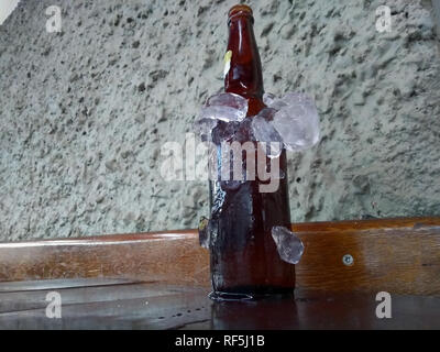 Les bouteilles de bière refroidi dans la glace. La bouteille de bière glacée sur le mur arrière-plan. Banque D'Images