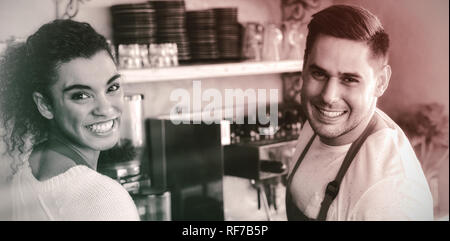 Smiling waitress and waiter in cafe Banque D'Images
