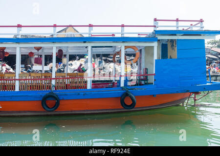 Ferry touristique bleu et rouge sur la rivière Thu Bon à Hoi An, Vietnam Banque D'Images