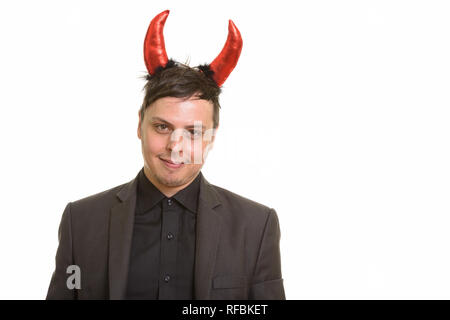 Portrait of happy Young businessman wearing devil horns Banque D'Images