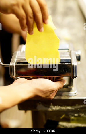 Chef faire des pâtes avec une machine, des pâtes fraîches faites maison Banque D'Images