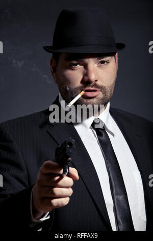 Homme dangereux en costume avec une arme à feu Banque D'Images