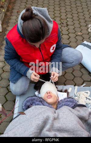 Sofia, Bulgarie - 5 décembre 2018 : agents paramédicaux de bénévoles de la Croix-Rouge jeunesse bulgare bandages bandage de tête lors d'une formation pour sauver des gens dans un Banque D'Images