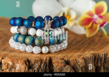 La femme exquise bracelets faits de pierres naturelles, de l'agate et quartz de sucre avec des accessoires qui sont incrustés de cubic zirconias. Close-up. Studio Banque D'Images