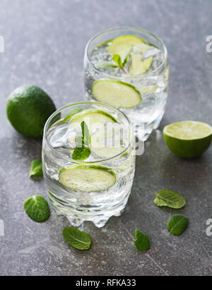 Deux verres de cocktail avec de la chaux sur fond d'ardoise Banque D'Images