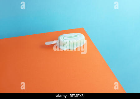 La fonte des glaces Glace sur fond bleu et orange Banque D'Images