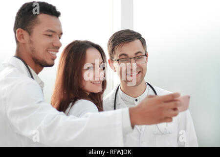 Équipe de médecins stagiaires en tenant vos autoportraits dans le hall de l'hôpital Banque D'Images