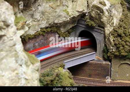 Modèle électrique sur train train miniature voie allant à travers le tunnel de montagne Banque D'Images