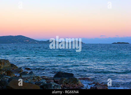 Coucher de soleil sur la mer des Caraïbes avec les Samoa américaines sur l'horizon. Soleil se couche derrière un paysage montagneux de l'île de Saint Thomas. Banque D'Images