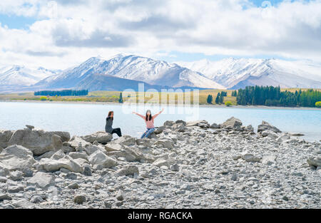 LAKE TEKAPO NOUVELLE-ZÉLANDE - 14 OCTOBRE 2018;Deux touristes yYoung profitez d'expérience de l'estran rocheux de faible niveau d'eau au bord du lac Banque D'Images