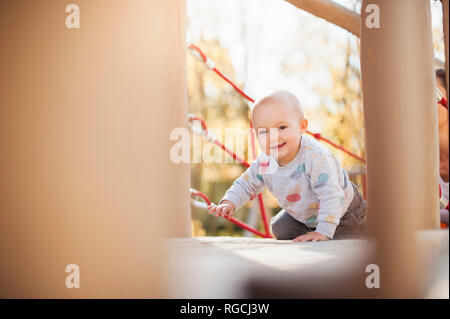 Portrait of happy baby girl on playground Banque D'Images