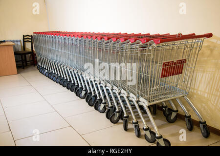 Des chariots alignés ensemble close up . De nombreux paniers vides consécutives. À l'intérieur d'un grand supermarché. Banque D'Images