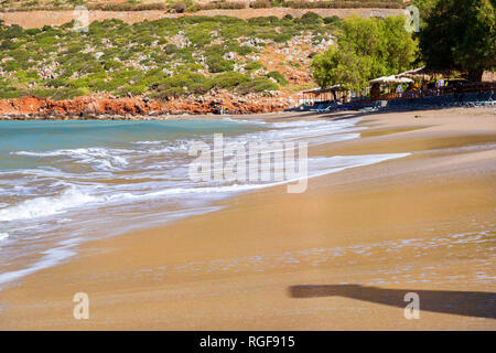 Surfez et vague de mousse des vagues sur une plage de sable. Sunny sandy Livadi Beach dans la baie de la mer de Bali village resort. Les vagues de la mer de sable de la plage déserte. Bali, Rethymno, Crète, Grèce Banque D'Images