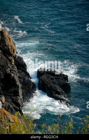 Se briser sur des rochers dans la mer Baye de la Forge sur la côte sud de Guernsey, Channel Islands Banque D'Images