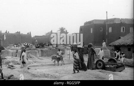 Construire des maisons traditionnelles 1950's Rural Village Scene, Cameroun Afrique Banque D'Images