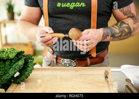 Nettoyage homme végétalien champignons dans sa cuisine Banque D'Images