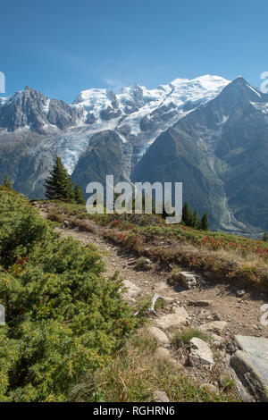 À la sentier de randonnée vers le bas sur une crête et à travers une vallée profonde vers le Mont Blanc et ses glaciers, les sommets et les forêts. Banque D'Images