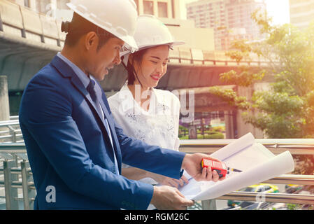 L'équipe de porter un casque et ingénieur radio utiliser la communication pour le contrôle des tâches de travail at construction site Banque D'Images