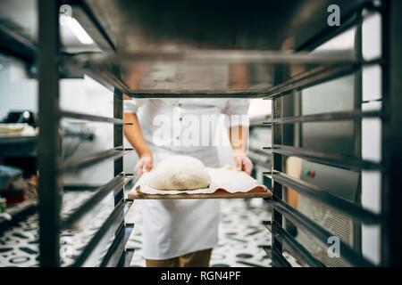 Baker working préparer le bac pour faire du pain Banque D'Images