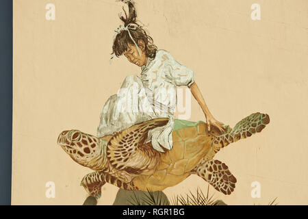 Travail art collaboratif entre les artistes de rue Ernest Zacharevic et Martin Ron. La peinture murale représentant une fille assise une tortue à George Town, Penang, Banque D'Images