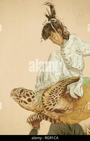 Travail art collaboratif entre les artistes de rue Ernest Zacharevic et Martin Ron. La peinture murale représentant une fille assise une tortue à George Town, Penang, Banque D'Images