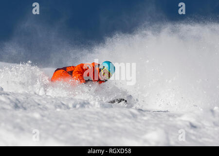 Un homme sur une planche à faire dans le tour de poudreuse profonde dans la station de ski de Courchevel en France Alpes. Banque D'Images