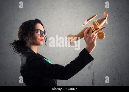 Businesswoman jouer avec un jouet avion. Concept de démarrage d'entreprise et la réussite de l'entreprise Banque D'Images