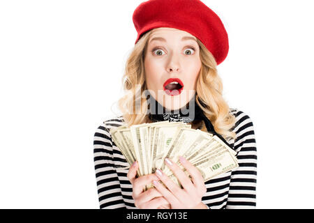 Surpris blond woman holding billets en dollar isolated on white Banque D'Images