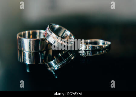 Les détails de la matinée du jour du mariage. Les anneaux de mariage sont sur la table. Banque D'Images