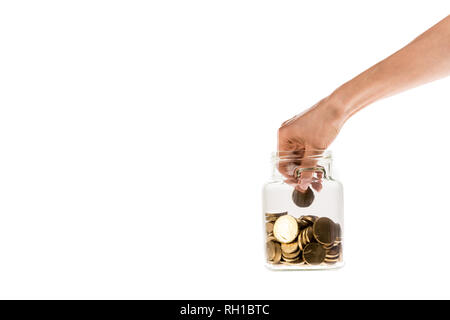Portrait of woman putting golden coins en bocal verre isolated on white Banque D'Images